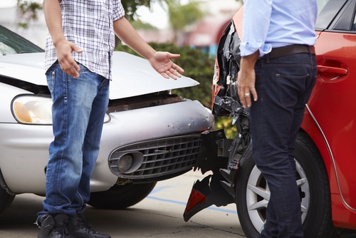two men trying to find consensus over a car accident they've just had