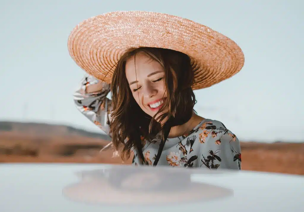 woman is happy about her car and vehicle insurance (with a low premium and high excess) that still gives her peace of mind on her roadtrip