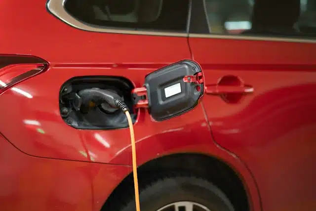Red electric car being charged.