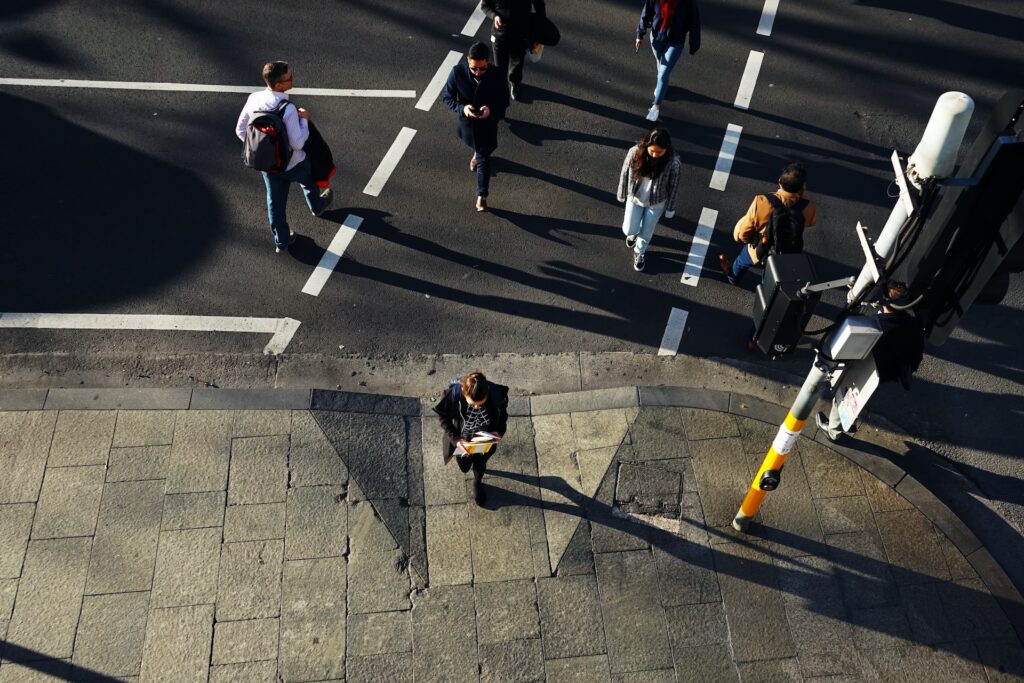 pedestrians cross a road at a traffic light
