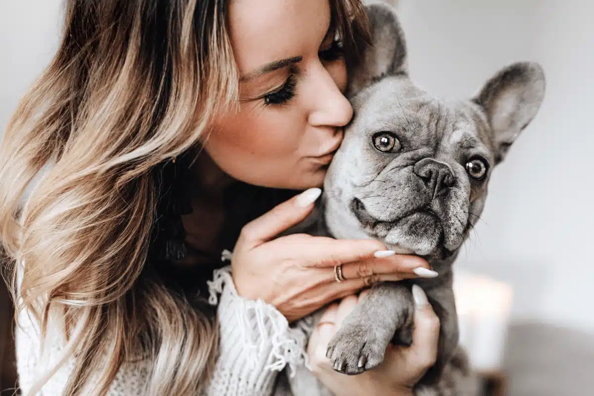 woman kissing dog