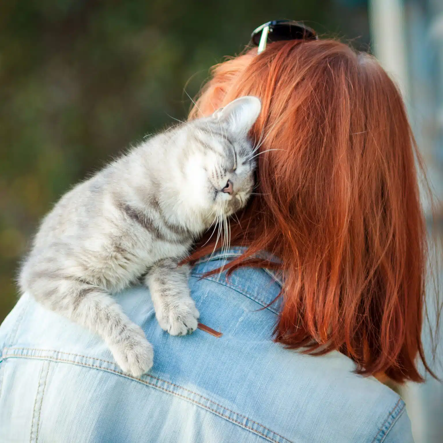 woman with cat sitting on shoulder