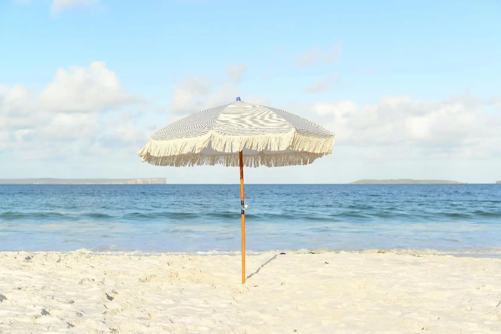 Image of white umbrella on sandy beach