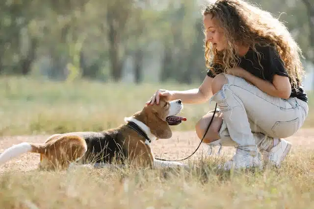 woman pets dog