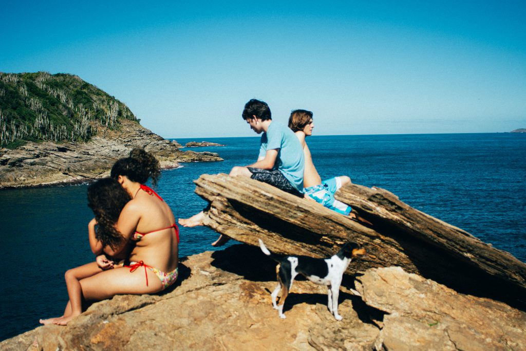children with dog by the sea