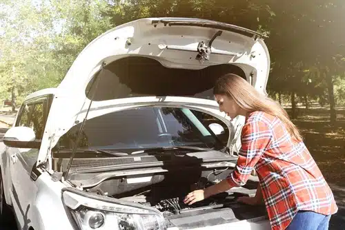 Woman checks her oil.