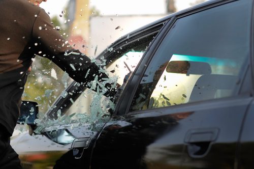 arm breaking window of black car in theft attempt