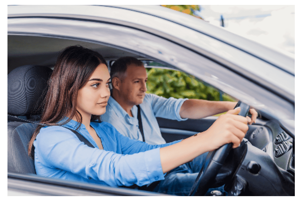young brunette woman having driving lessons with older male driving instructor