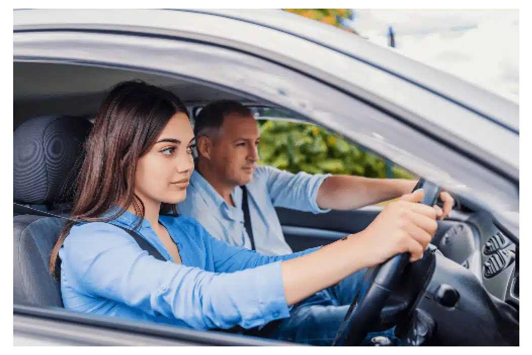 young brunette woman having driving lessons with older male driving instructor