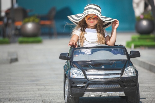 little girl driving battery powered car