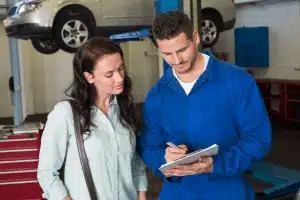 mechanic explains car service quote to woman