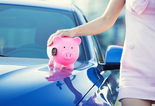 this woman with a piggy bank is saving money for a car