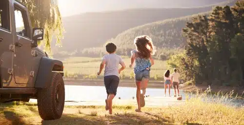 kids running to water on holiday road trip