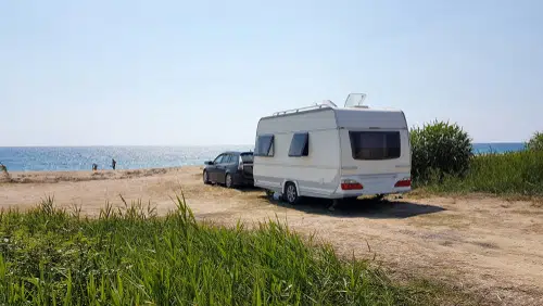 one of the best towing cars with caravan attached on beach
