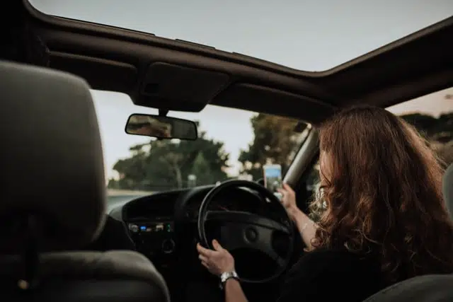 car insurance for young drivers is more expensive because some young drivers like this woman drive and text. one of our tips for first time car buyers is that they should consider car insurance for financial protection