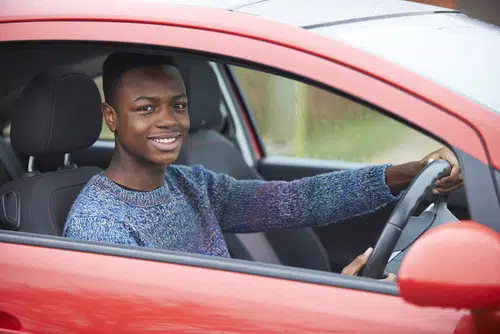 teenage young driver has insurance for the red car he is driving