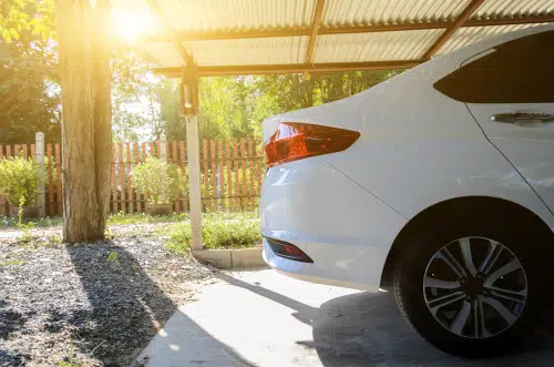 white car in garage - if your car will be parked and not used you might not need a car insurance policy