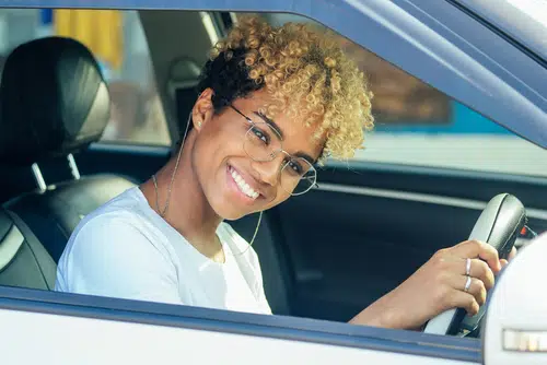 10 tips for first time car buyers would be useful for this teenage girl with glasses sitting in her new car