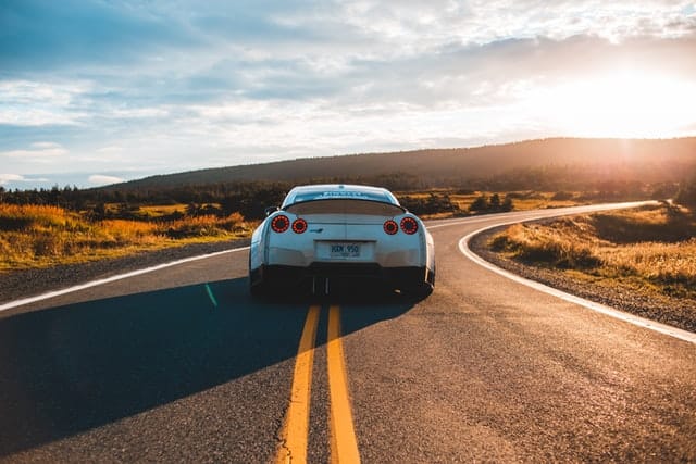 luxury car sound is carefully designed - like for this silver sports car on the open road