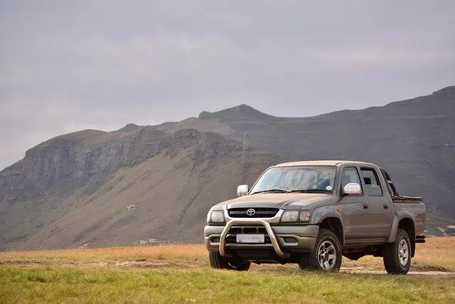 grey high mileage car or ute in front of mountains
