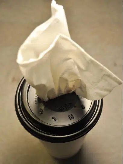 A washed and dried takeaway coffee cup and lid make a great tissue dispenser for your car