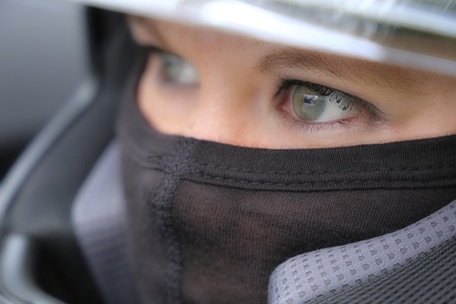 close up of female race car driver in helmet