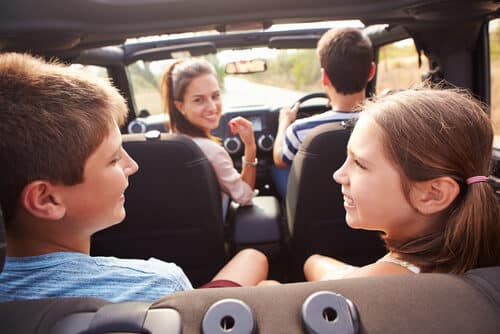 family talking about games to play in the LPG gas run car