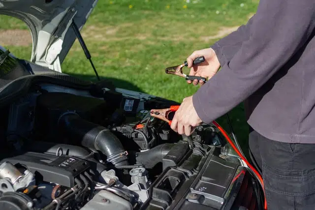 A person wondering how to jump start a car