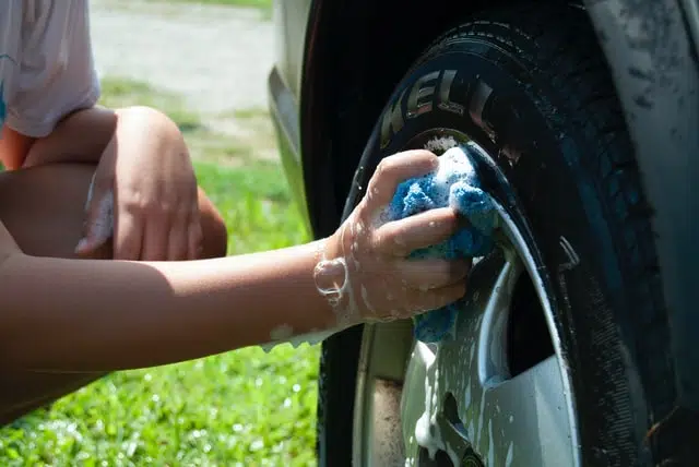 a woman spring cleaning a car