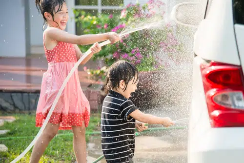 kids spring cleaning a car