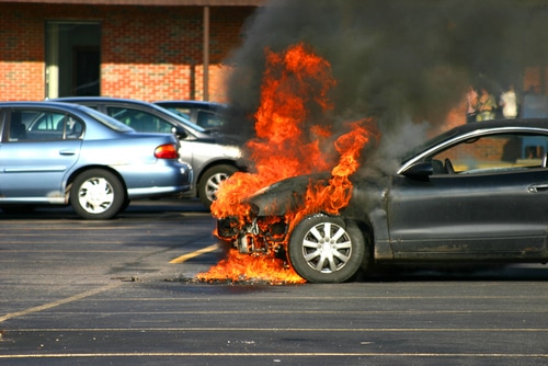 third party car insurance for fire and theft covers cars which are on fire like this black one in a car park