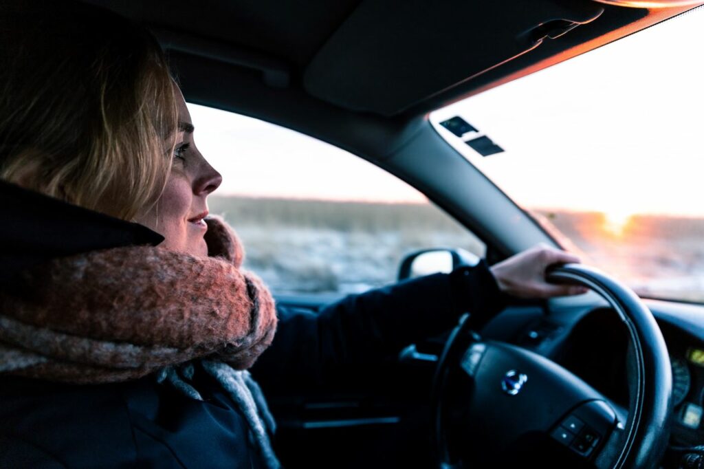 this woman in a scarf is enjoying safe solo travel in Australia in her car