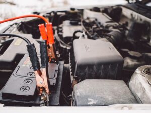 jump starter cable clips attached to car battery
