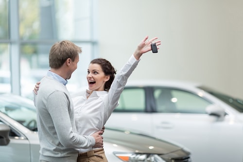 happy couple who have bought new car knew how much to spend