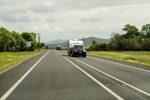 black diesel 4x4 car towing caravan on highway in Australia in Queensland