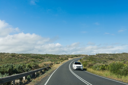 White car on open road in Australia