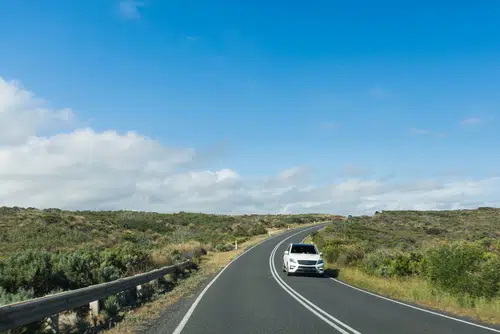 White car on open road in Australia