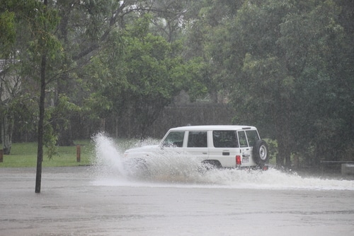 white SUV car driving through deep water in Australia