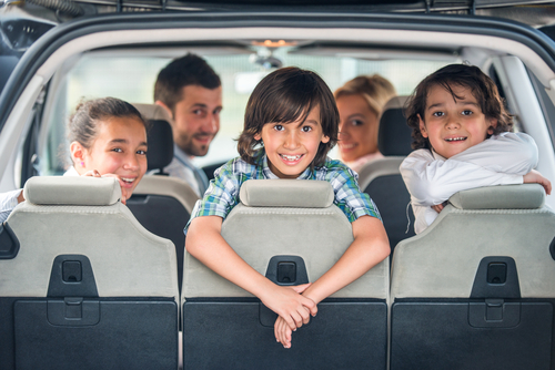 kids and mum and dad go on a road trip in an SUV