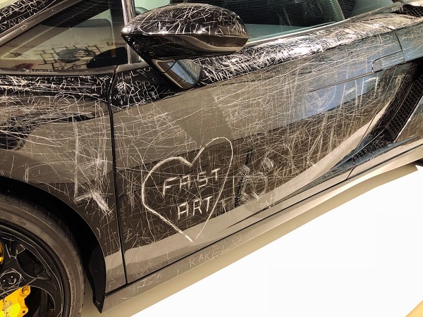 This black scratched car may leave its owner wondering does car insurance cover vandalism