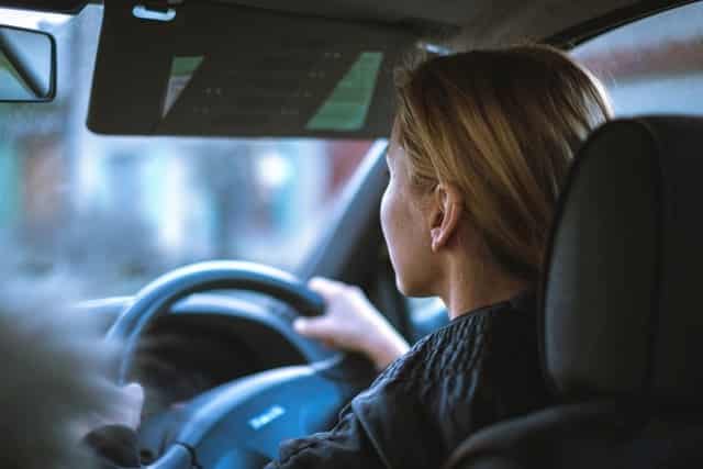 shot of middle aged woman driver from behind