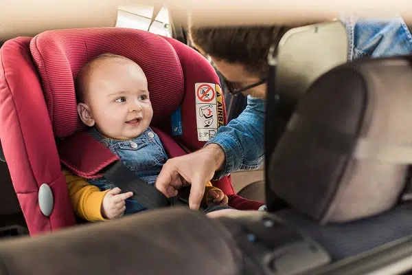Father fastens his little baby
