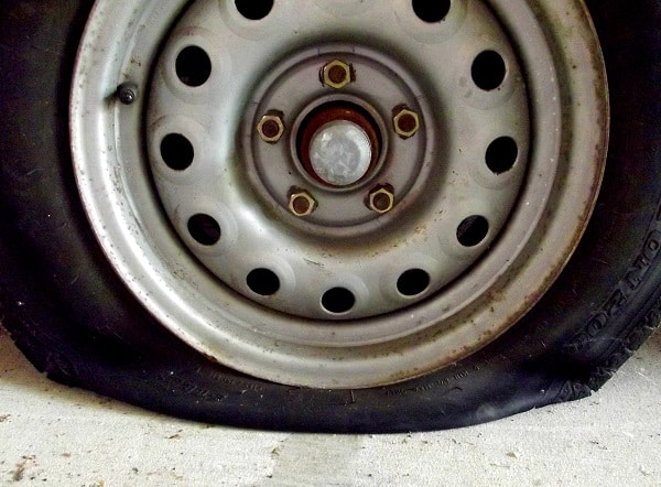 A flat tyre that will need tyre puncture repair 