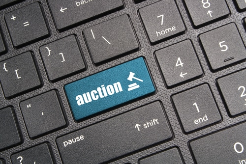 A keyboard with a button that says 'auction.' buying cars at auction can save you money