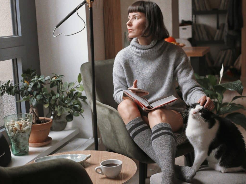 woman considers the future health needs of her cat and getting a pet plan