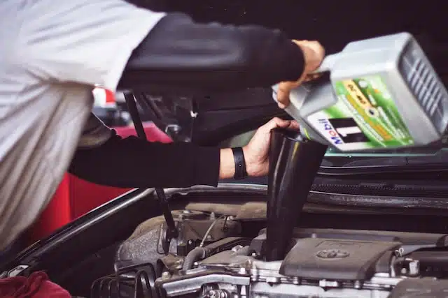 mechanic doing a car service and battery replacement