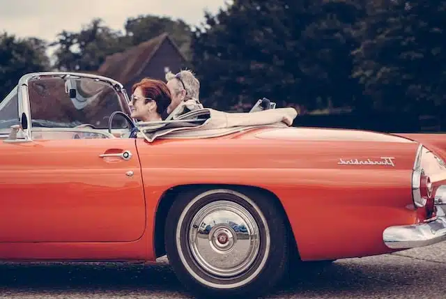 And older couple in a red thunderbird convertible. Are convertible cars worth it? You have to weigh up the pros and cons of convertibles before making that decision