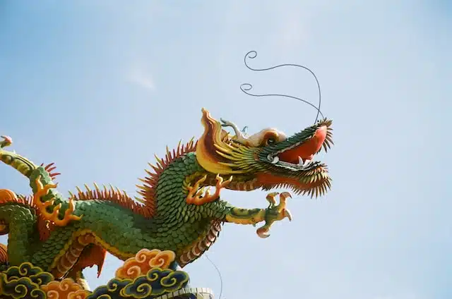 Chinese dragon statue against a blue sky, capturing the essence of Chinese New Year celebrations and the Year of the Rabbit in the Chinese zodiac.