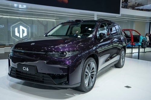 A dark purple electric SUV, model C16, is displayed at an auto show, showcasing the latest advancements that highlight the ongoing debate of electric vs petrol cars in 2023.