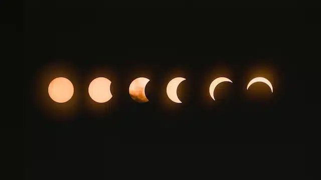 A series of different phases of a solar eclipse during the Chinese New Year, aligning with the Year of the snake and showcasing various Chinese zodiac animals.
